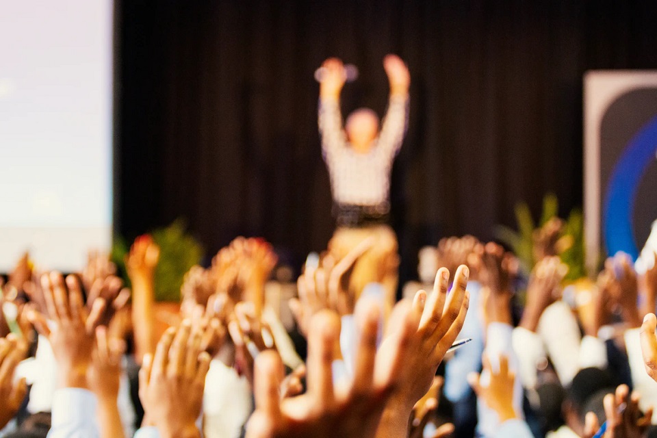 event attendees with raised hands