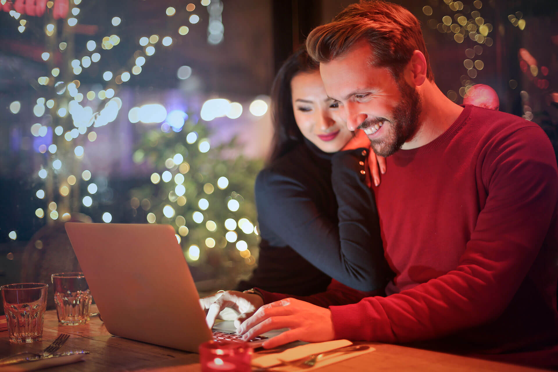 man and woman looking at laptop