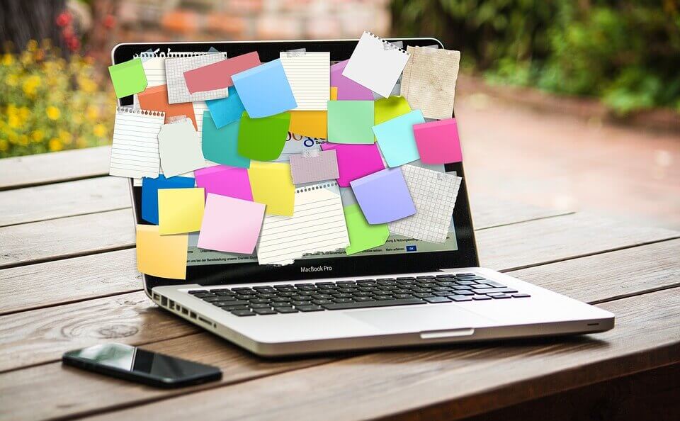 laptop covered in sticky notes
