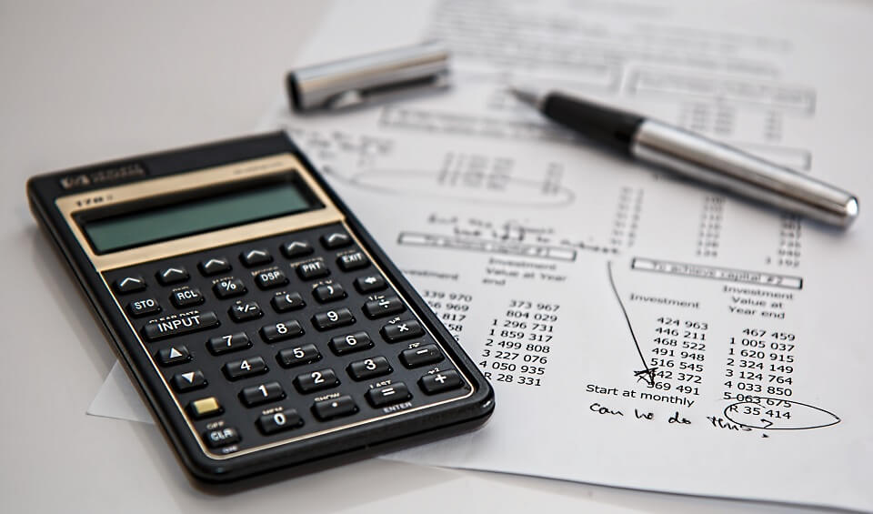 calculator and planning sheet with a ballpoint pen