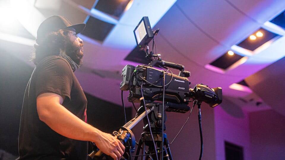 camera operator filming an online conference