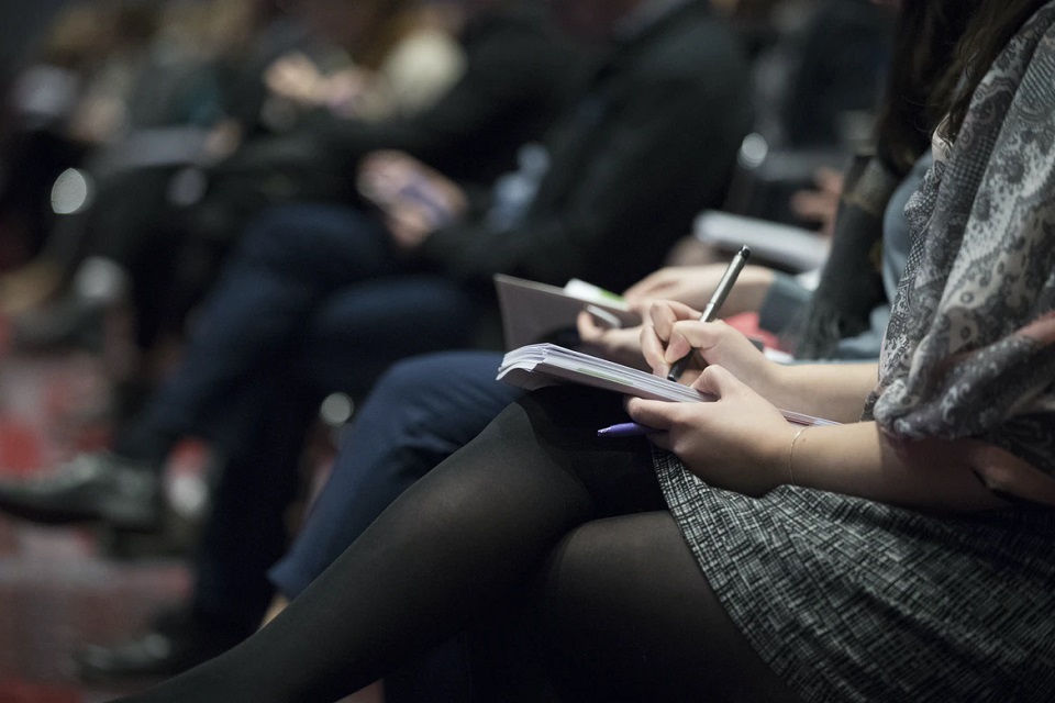 event attendees taking notes