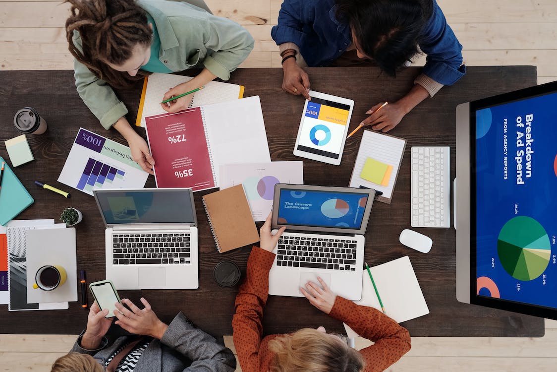 group of event organizers reviewing all the data from their latest event