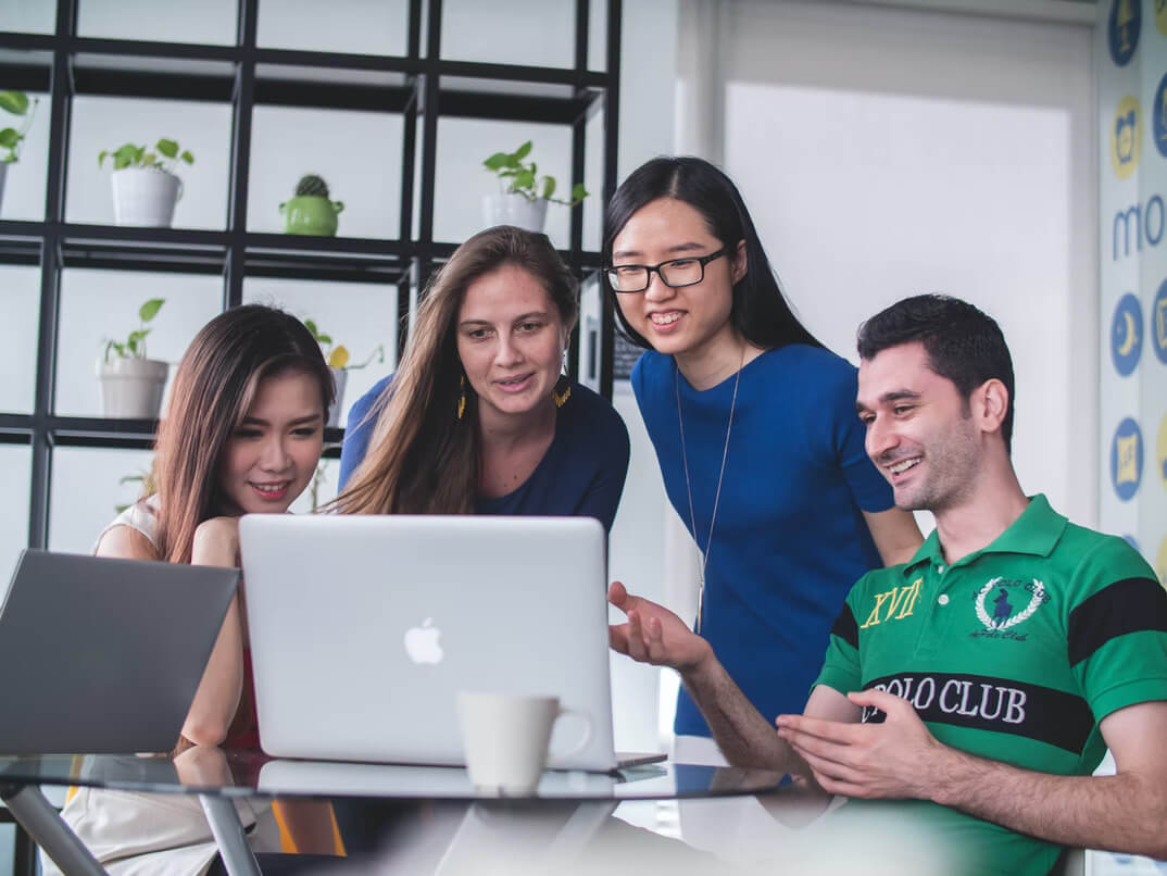 group of people looking at laptop