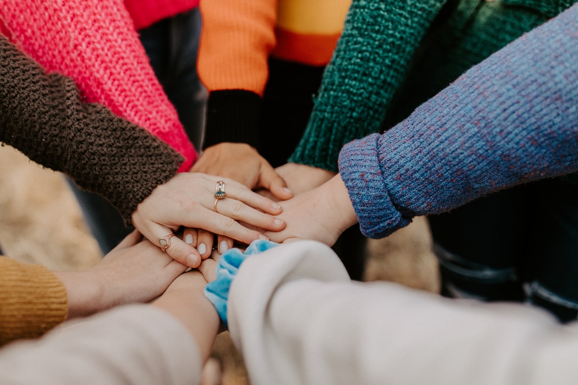 people forming a hand-stack