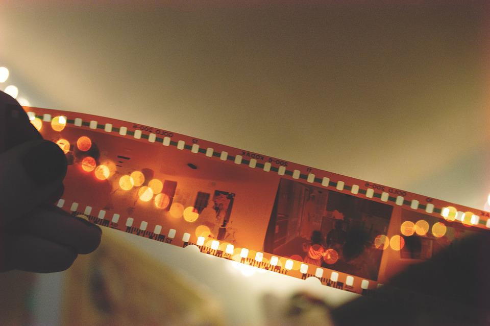 hands holding cinema film reel