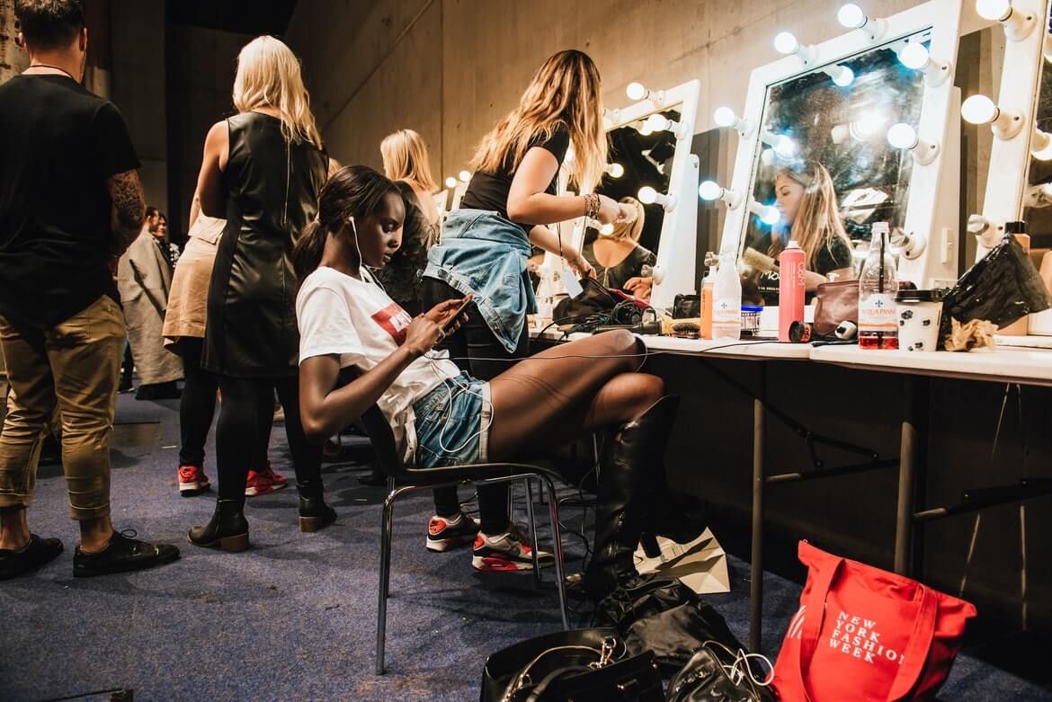 models preparing backstage for fashion show