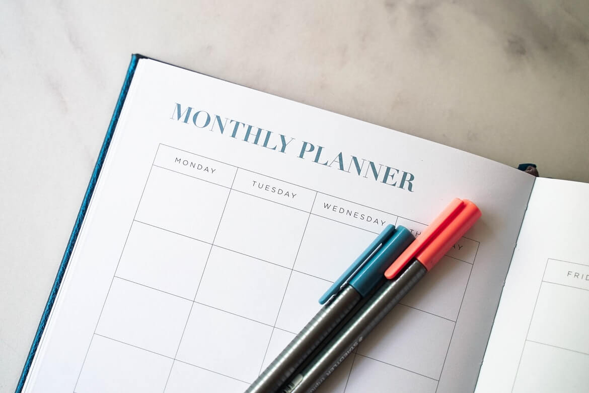 monthly planner book with pens