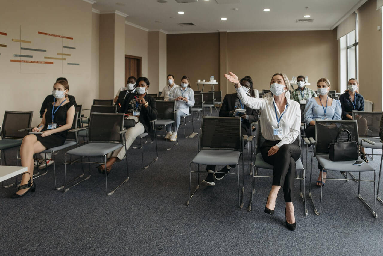 people wearing masks at small event