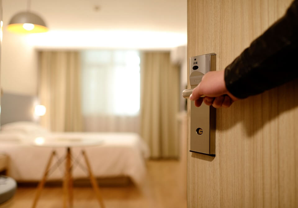 Person pening hotel room door