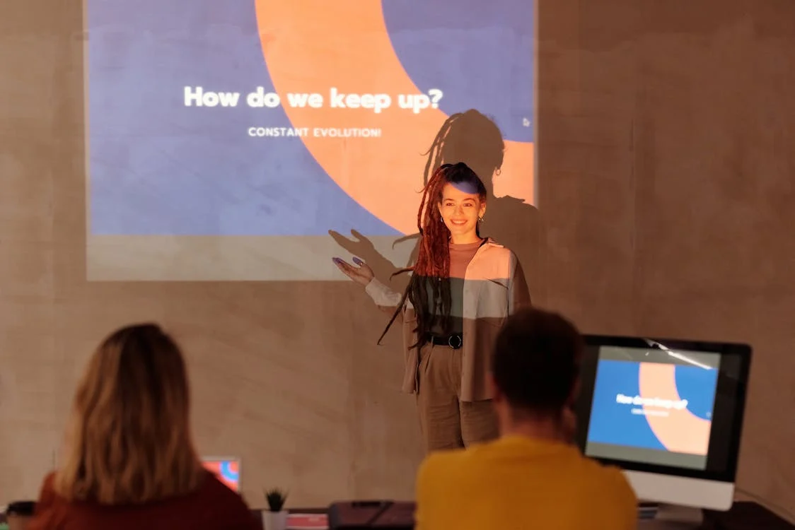 smiling woman giving presentation at conference