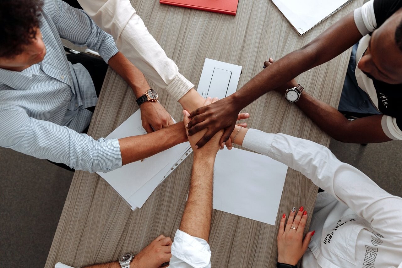 team members stacking hands