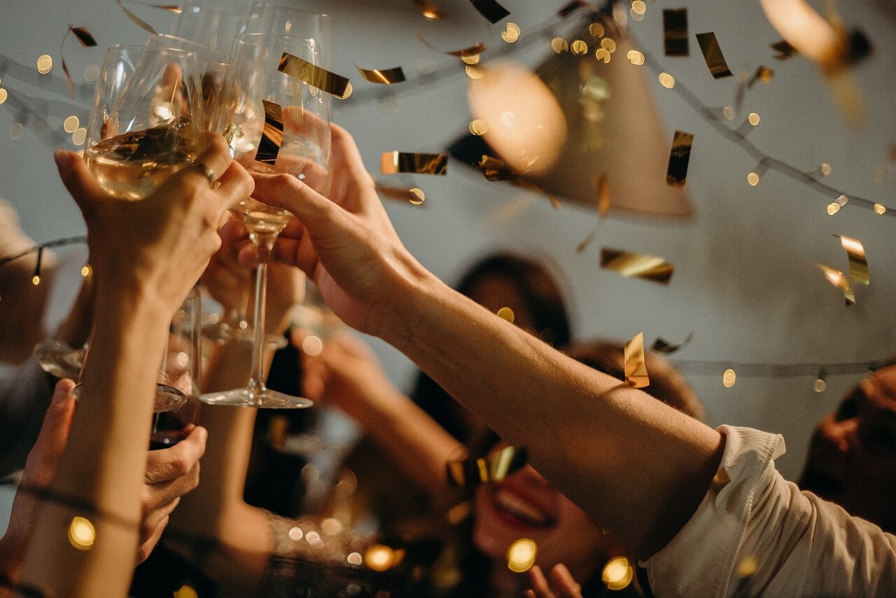 people toasting wine glasses at party