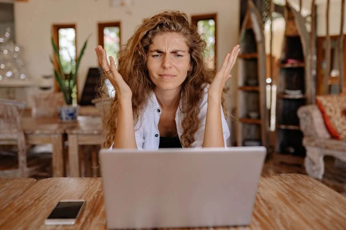 woman looking at computer in frustration
