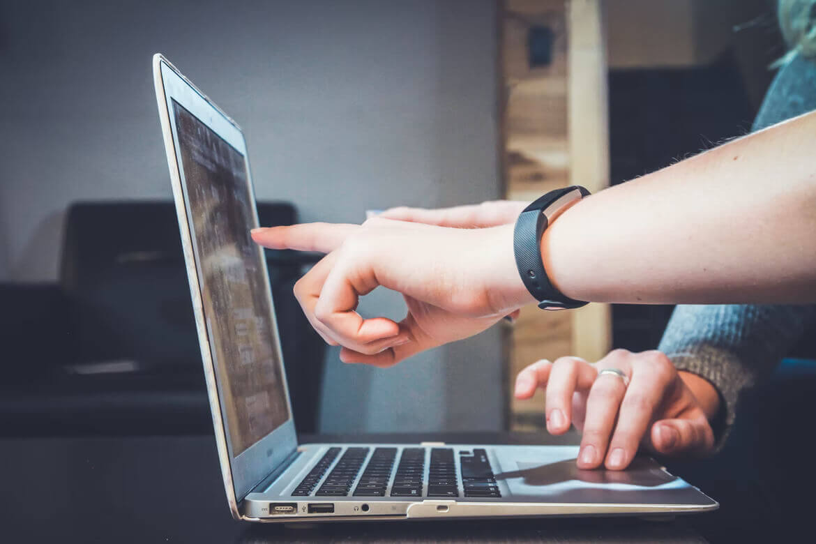 people working on laptop and pointing