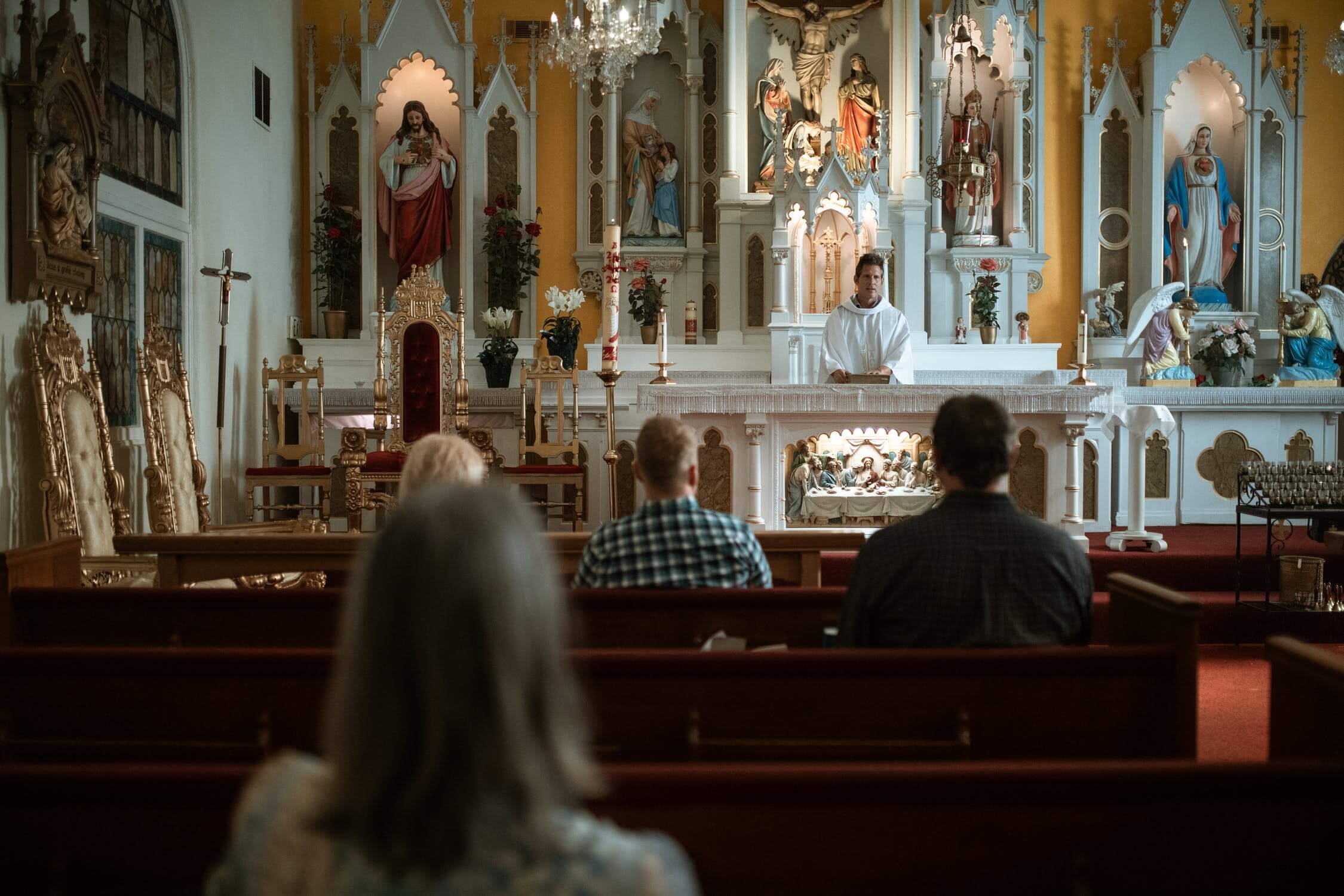 people sitting in pews during mass