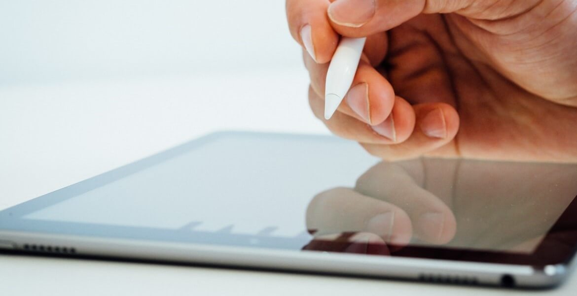 person holding white stylus pen